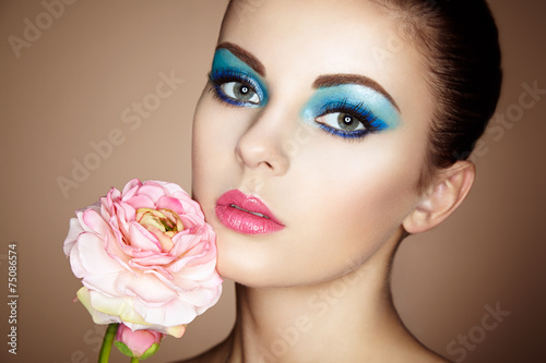 Portrait of beautiful young woman with flowers