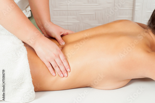 Young women getting back massage in massage salon