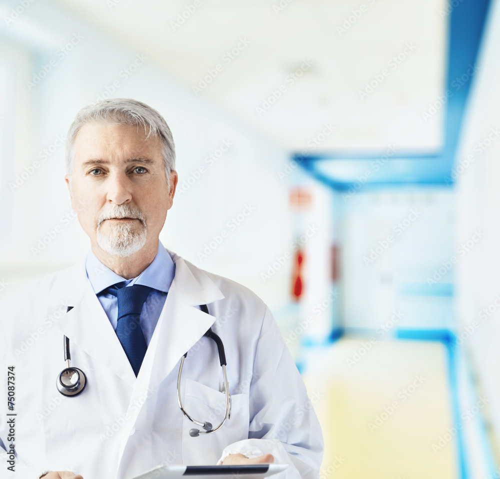 Doctor in the hospital hallway with tablet Doctor in the hospital hallway with tablet