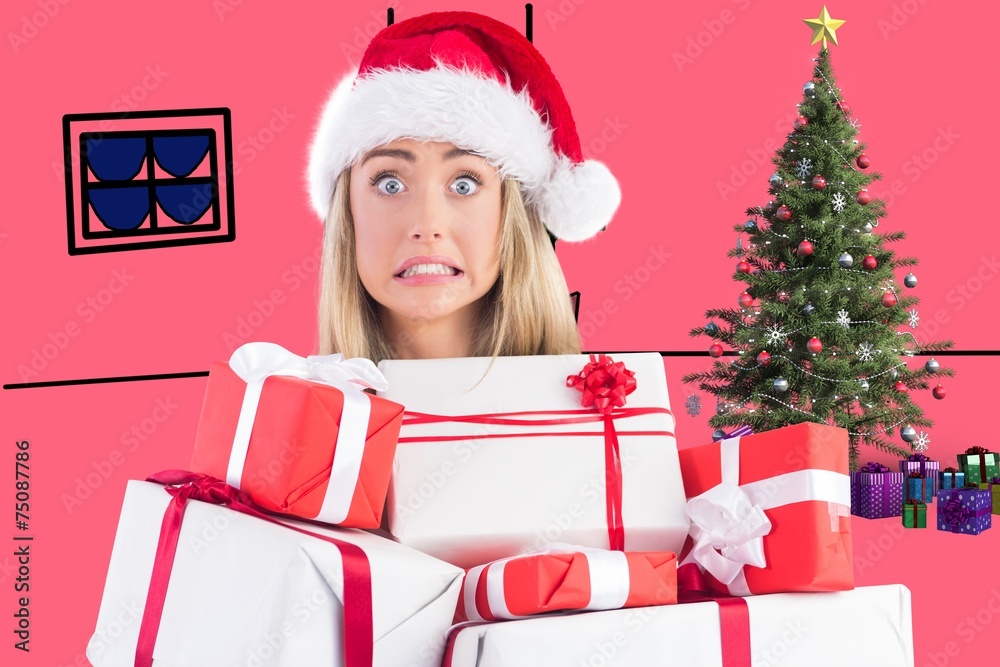 Composite image of festive blonde holding pile of gifts Composite image of festive blonde holding pile of gifts
