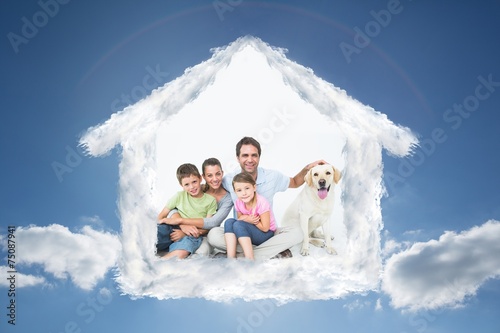 Cute family with pet labrador posing and smiling at camera
