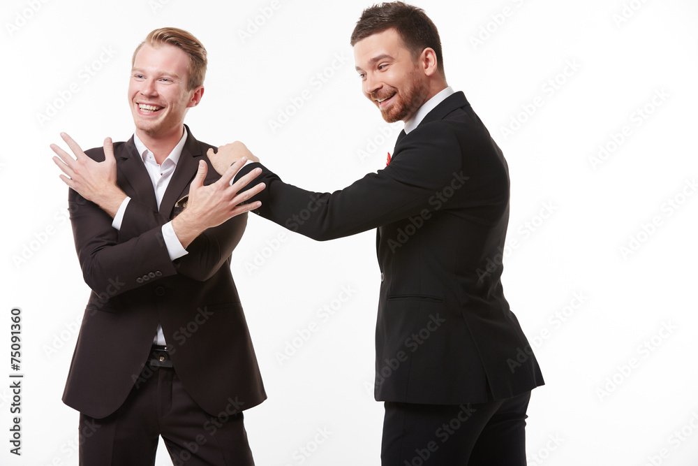 Two young men in suits talking having fun Two young men in suits talking having fun