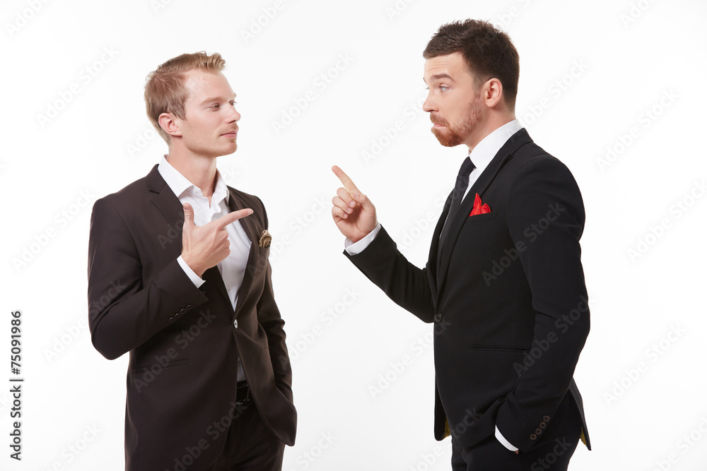 Two young men in suits talking having fun Two young men in suits talking having fun