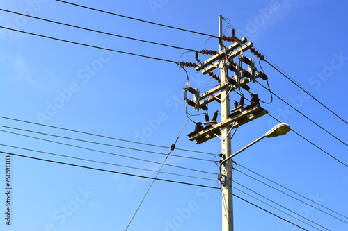 Electricity post on the blue sky.