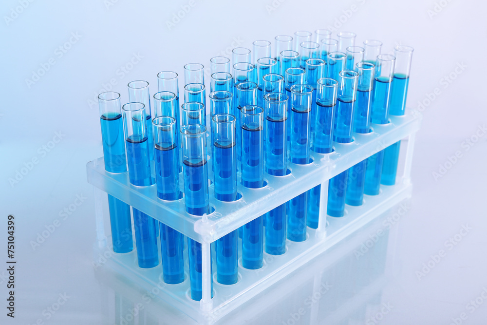 Blue water in a transparent test-tube on light background