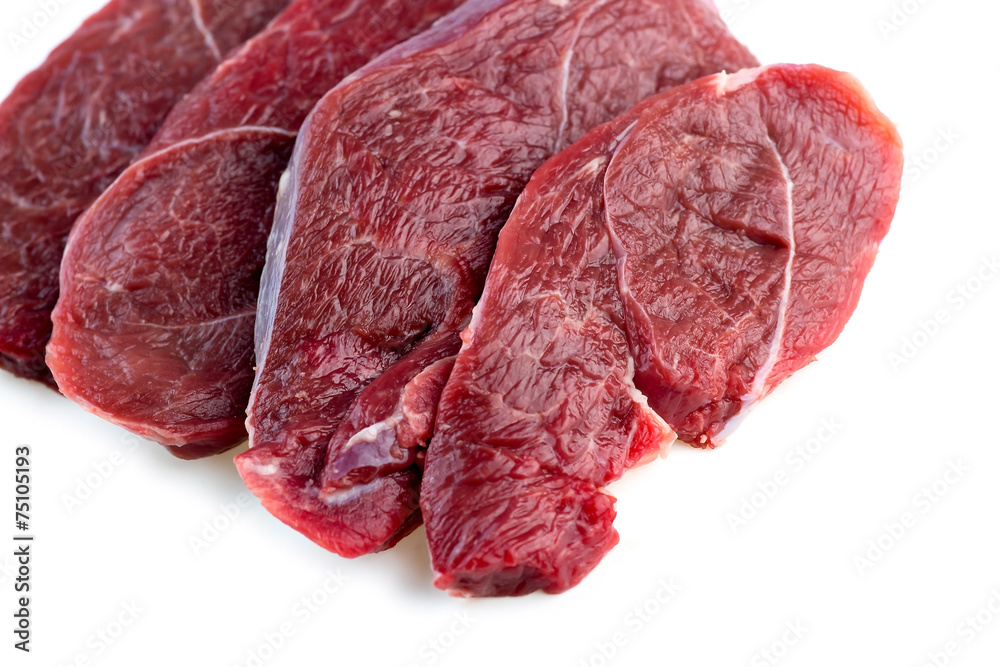 Fototapeta premium Studio shot of raw red meat steaks isolated against a white back