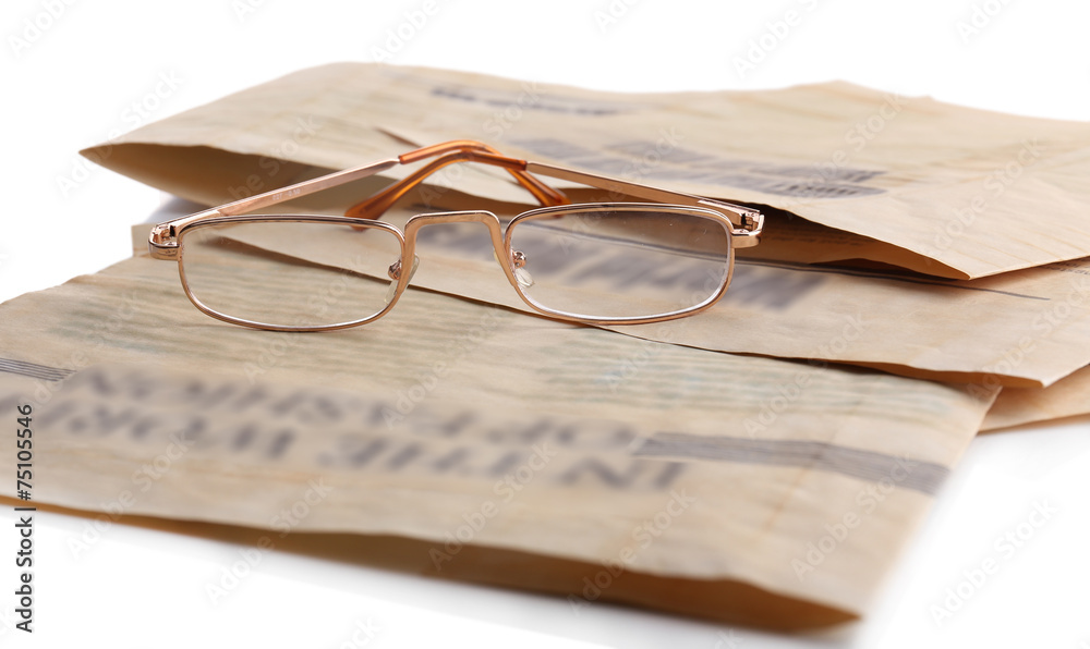 Glasses and newspapers, close-up Glasses and newspapers, close-up