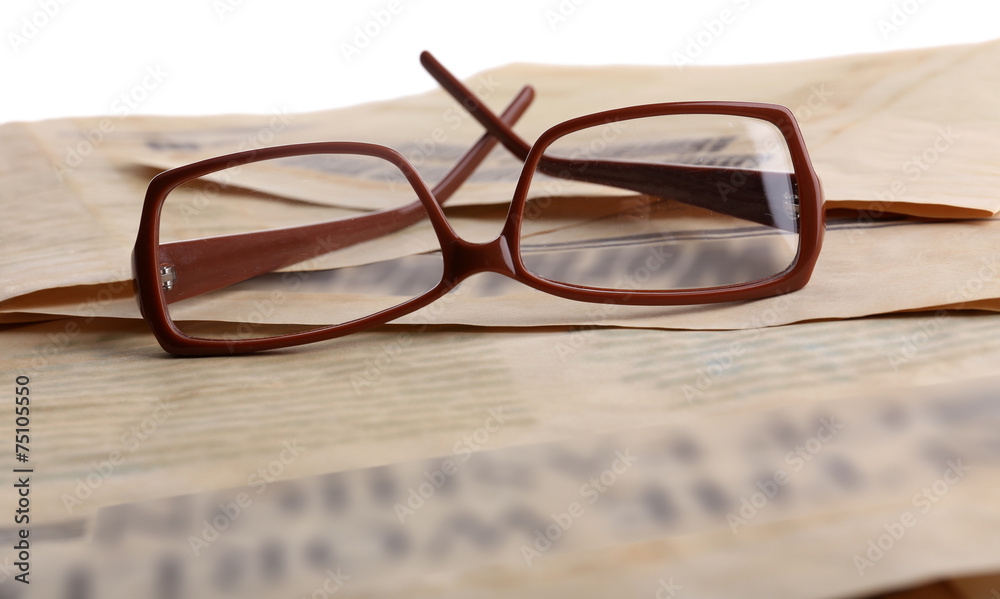 Glasses and newspapers, close-up Glasses and newspapers, close-up