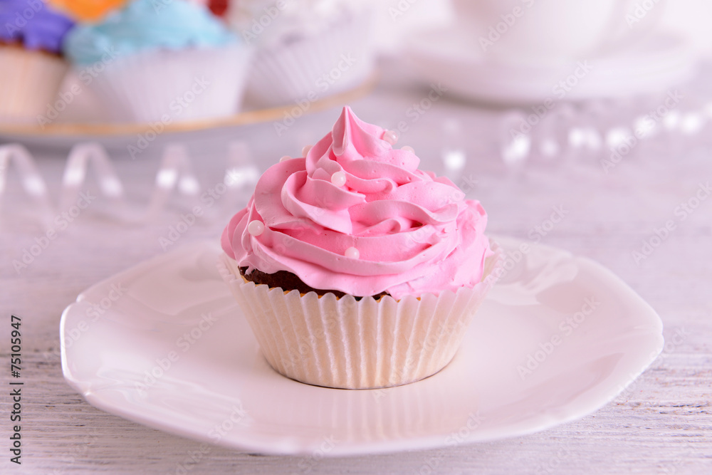 Delicious cupcakes on plate on table close-up Delicious cupcakes on plate on table close-up