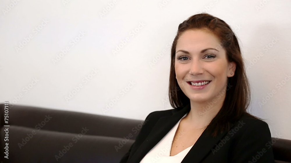 Attractive businesswoman in a suit sitting down Attractive businesswoman in a suit sitting down