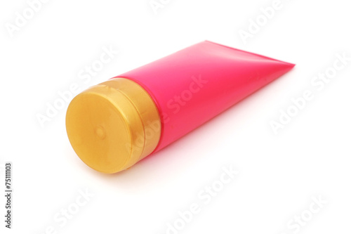 pink plastic tube with closed yellow flip top lid