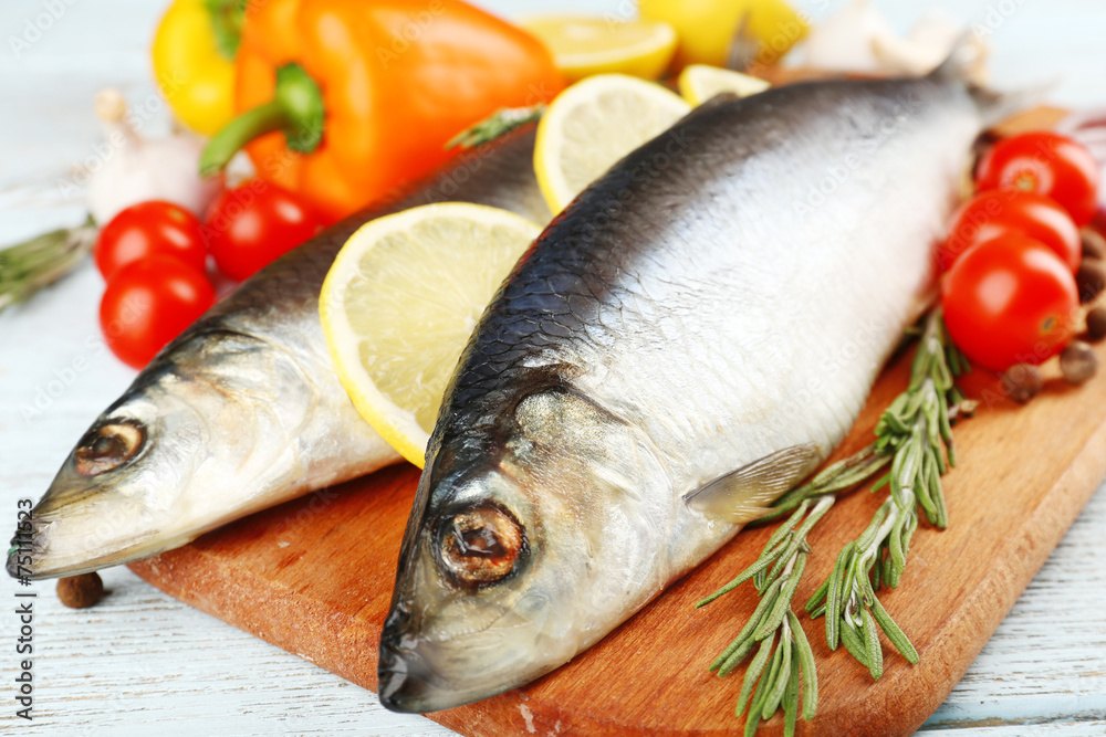 Fresh raw fish and food ingredients on table Fresh raw fish and food ingredients on table