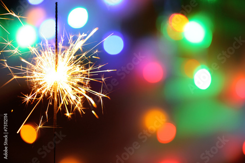 Beautiful sparkler on shiny background, close up