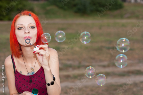 Pretty Girl Blows Bubble near the river