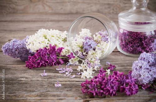 The beautiful lilac in jar on a wooden background