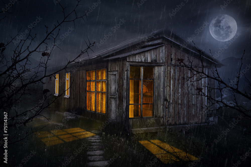 House with glowing windows at night House with glowing windows at night