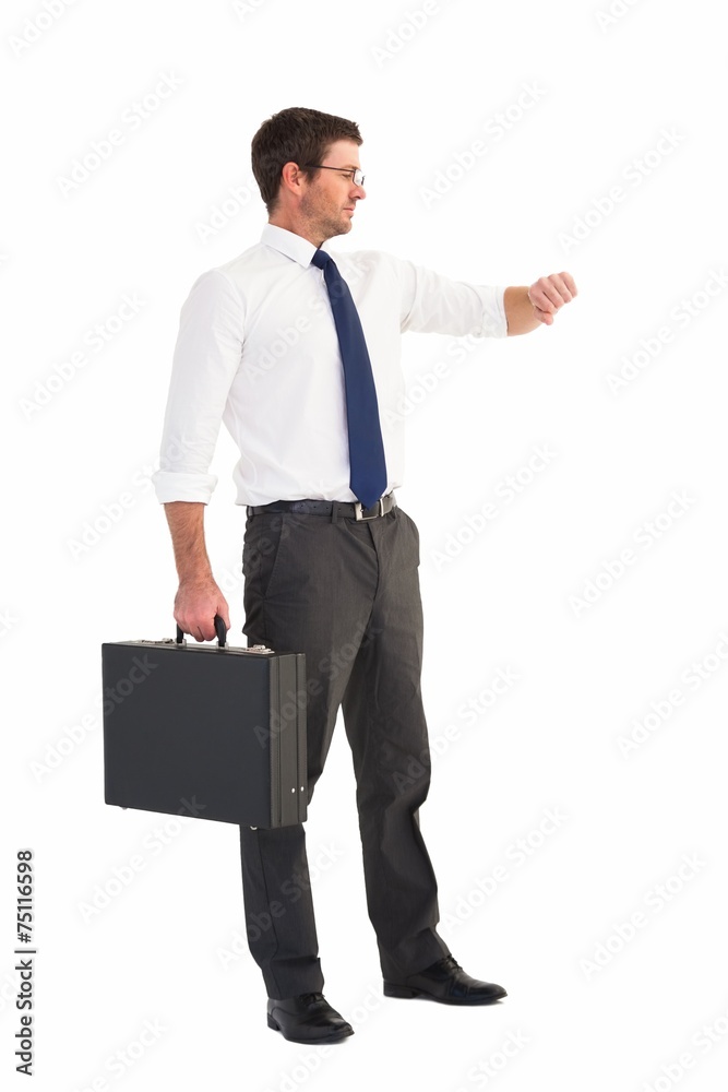Businessman checking the time while holding briefcase Businessman checking the time while holding briefcase