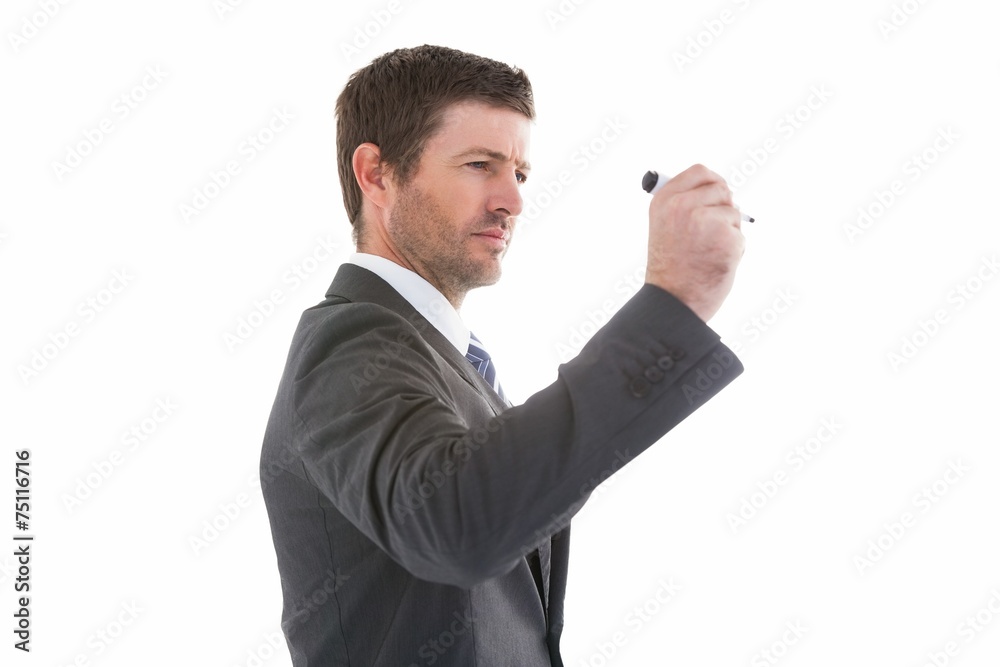 Serious businessman holding a marker and writing Serious businessman holding a marker and writing