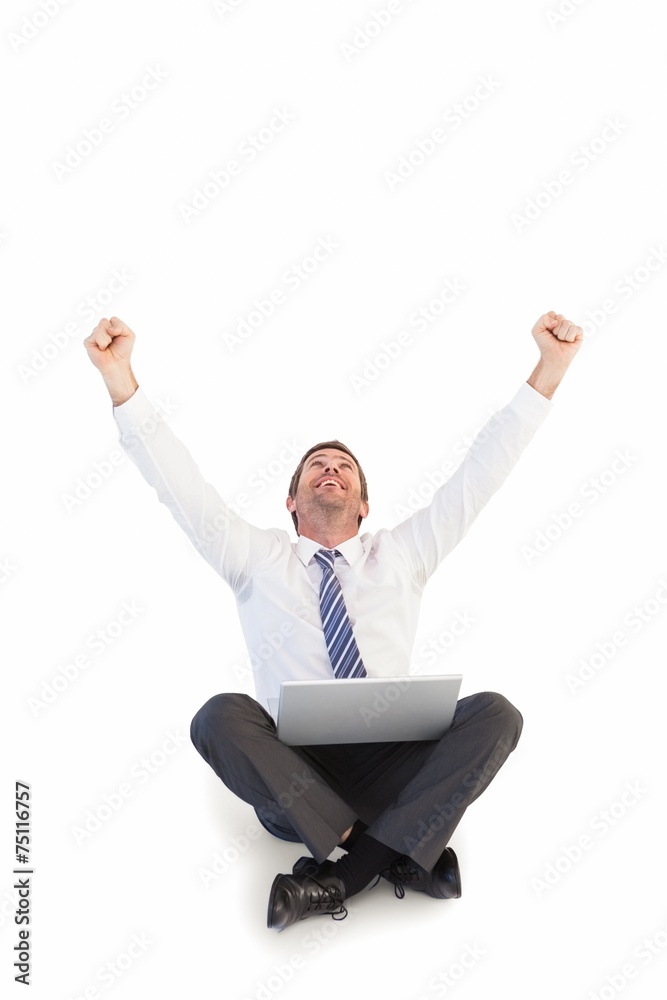 Excited cheering businessman sitting using his laptop Excited cheering businessman sitting using his laptop