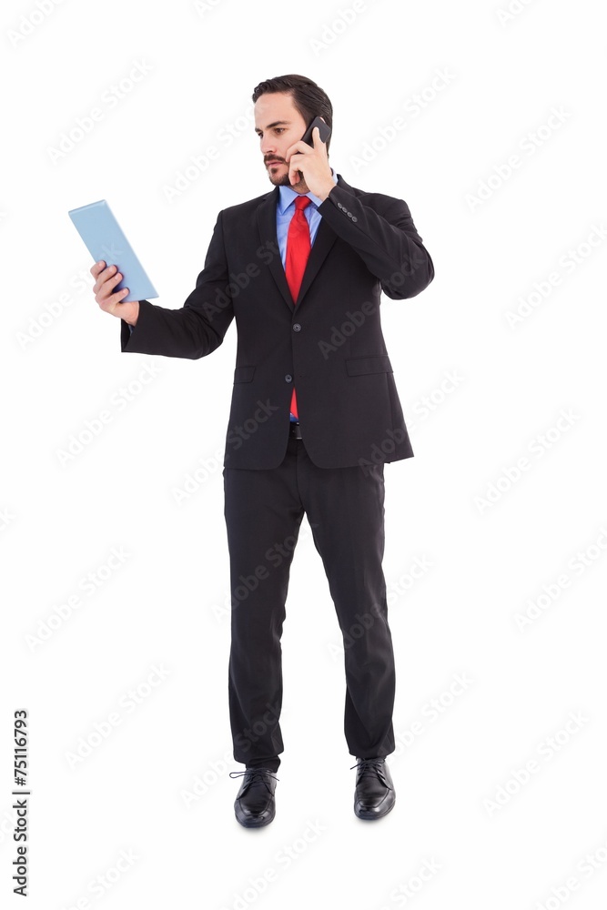 Businessman talking on phone holding tablet pc Businessman talking on phone holding tablet pc
