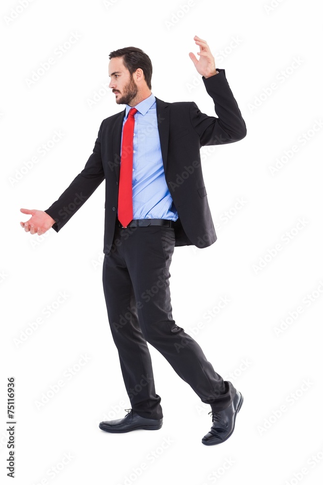 Focused businessman holding something with his hands Focused businessman holding something with his hands