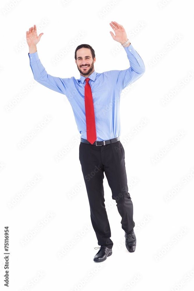 Smiling businessman stepping with hands raised Smiling businessman stepping with hands raised