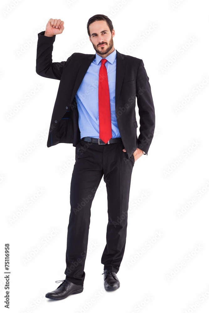 Unsmiling businessman standing with hand raised Unsmiling businessman standing with hand raised