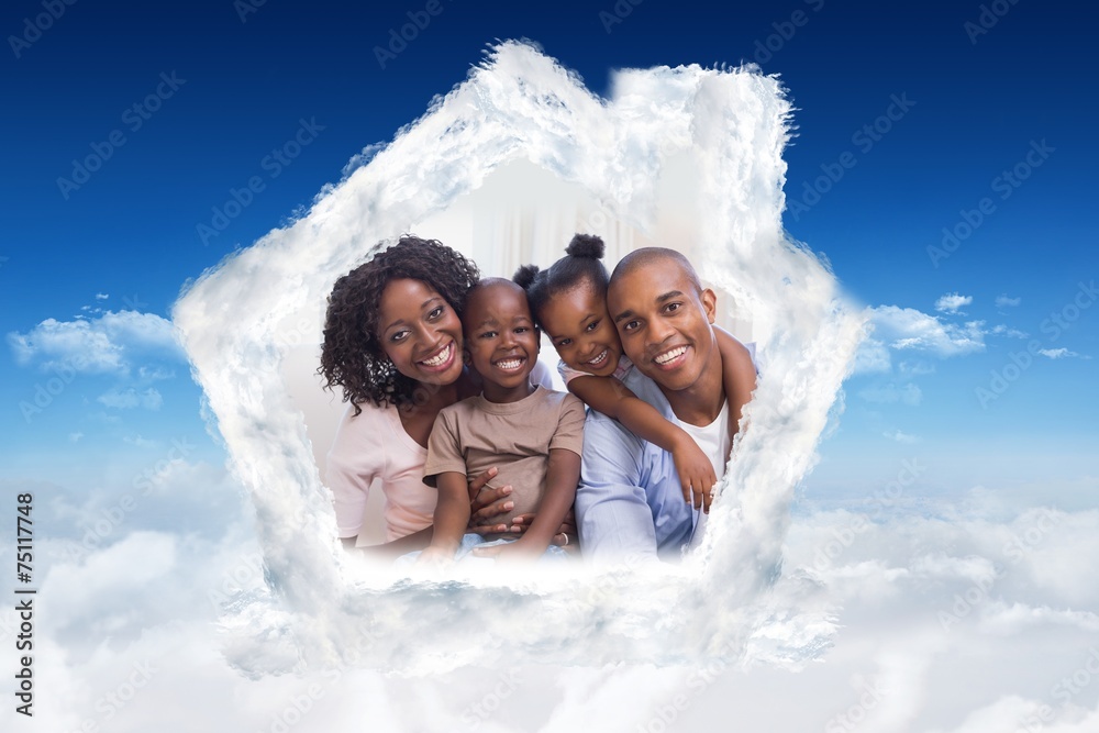 Composite image of happy family posing on the couch together Composite image of happy family posing on the couch together