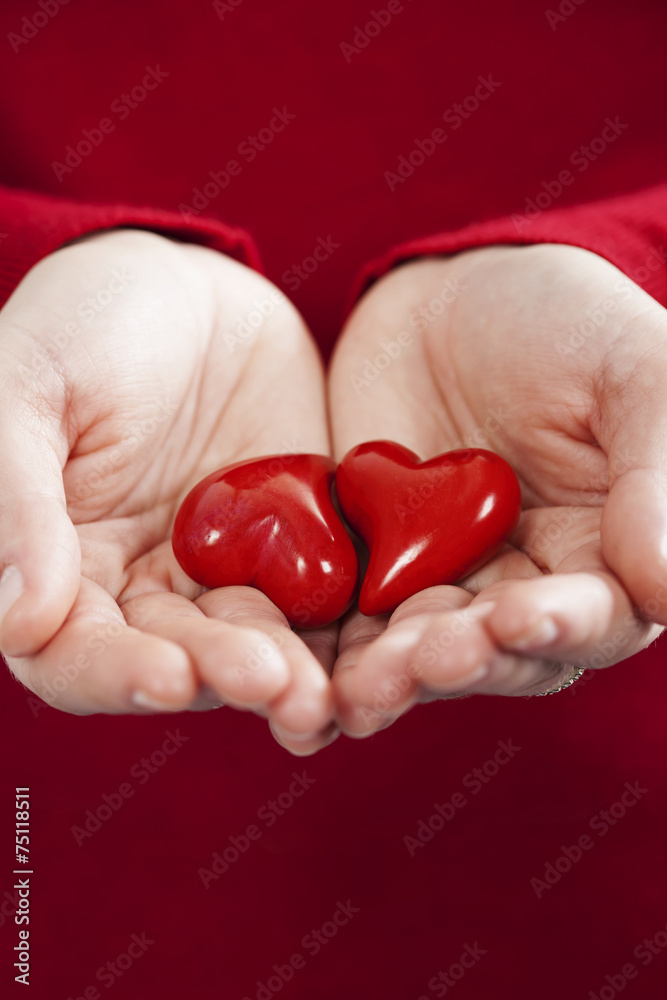 Red hearts in hands - St. Valentine concept Red hearts in hands - St. Valentine concept