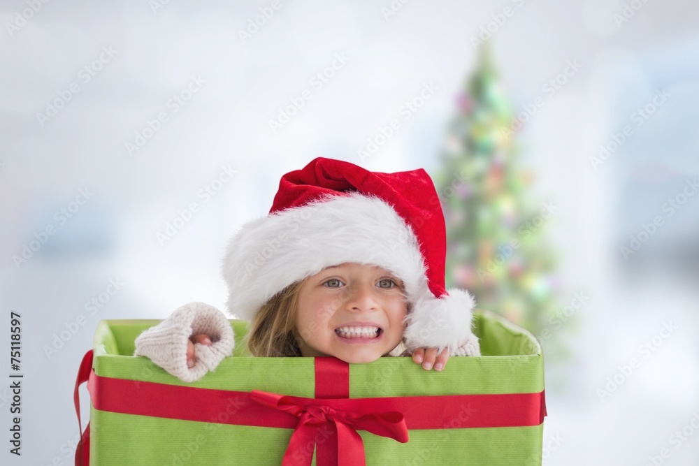 Composite image of cute girl in large gift Composite image of cute girl in large gift
