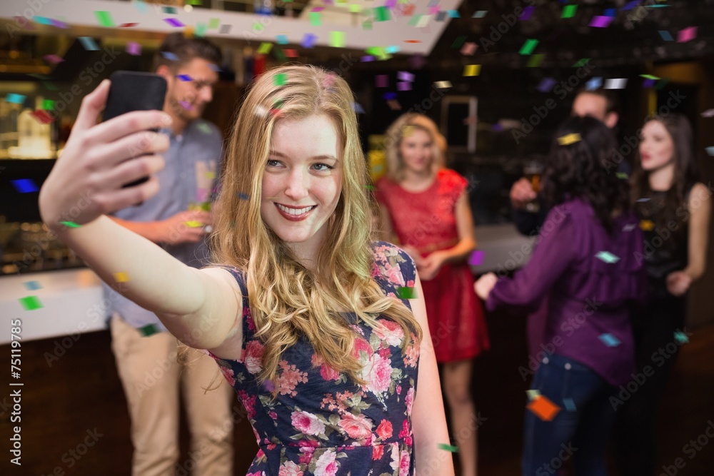 Composite image of pretty blonde taking a selfie
