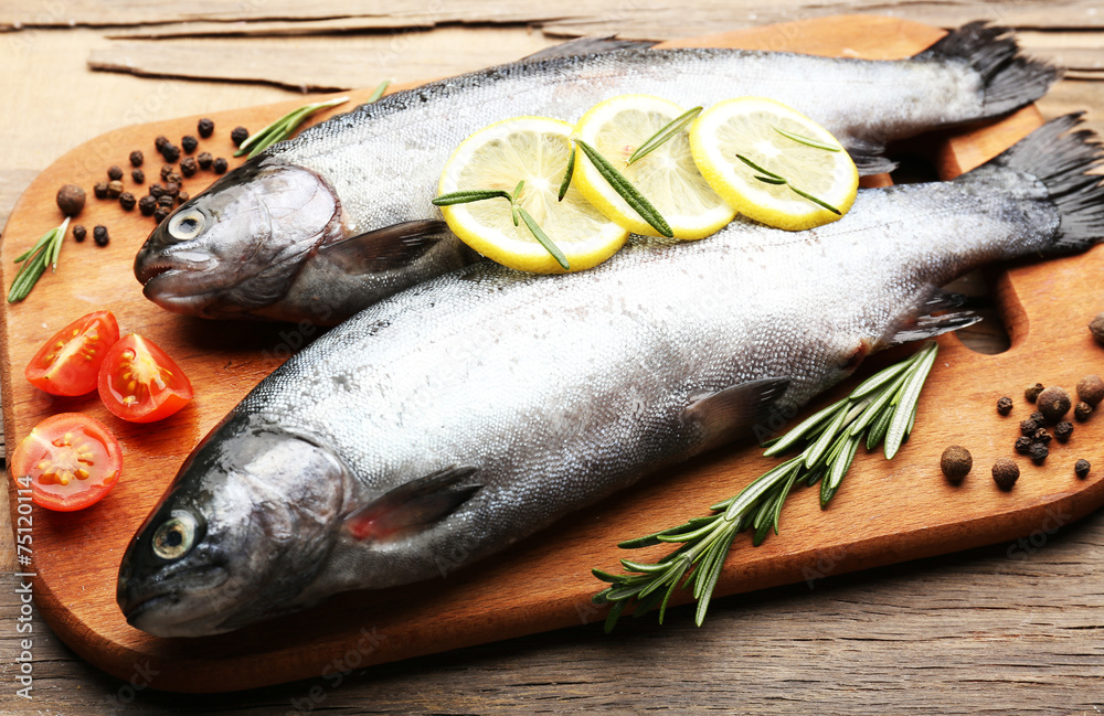 Fresh raw fish and food ingredients on table Fresh raw fish and food ingredients on table