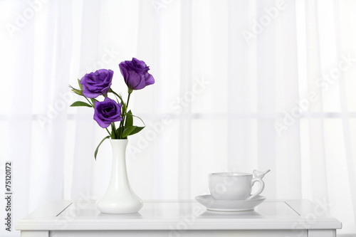 Beautiful bouquet of flowers in vase on window background