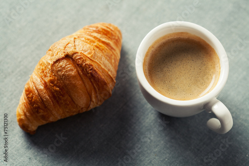Breakfast concept  cup of coffee and croissant