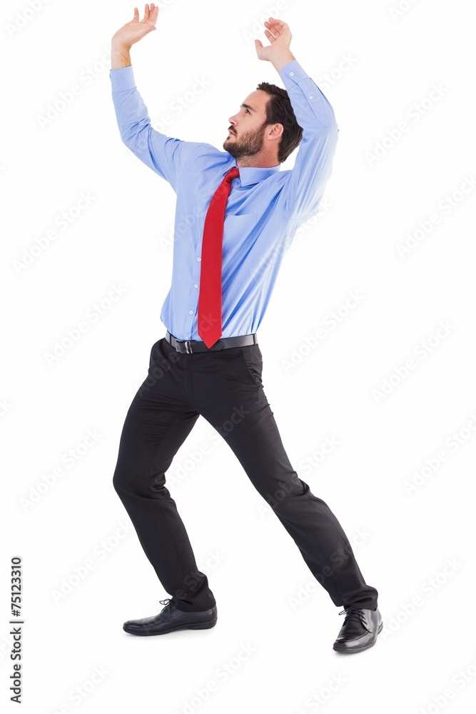 Focused bending businessman pushing while looking up Focused bending businessman pushing while looking up