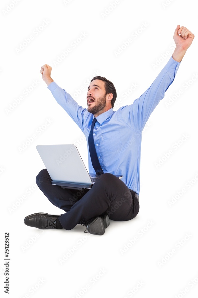 Excited cheering businessman sitting using his laptop Excited cheering businessman sitting using his laptop