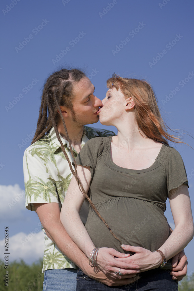 Kissing Couple awaiting a Baby