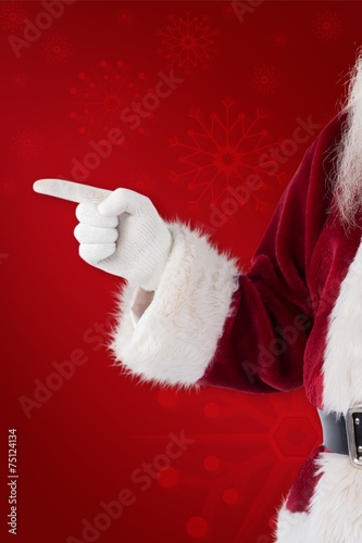 Composite image of santa claus points at something