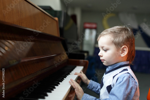 Child playing the piano © Arkady Chubykin