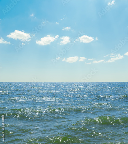 waves on sea and blue sky with clouds © Mykola Mazuryk