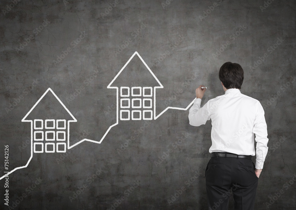 businessman drawing graph with house businessman drawing graph with house