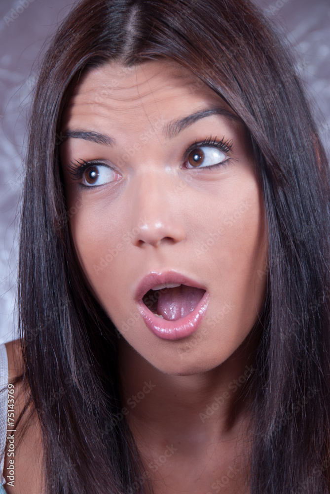 Young brunette woman making face expression Young brunette woman making face expression