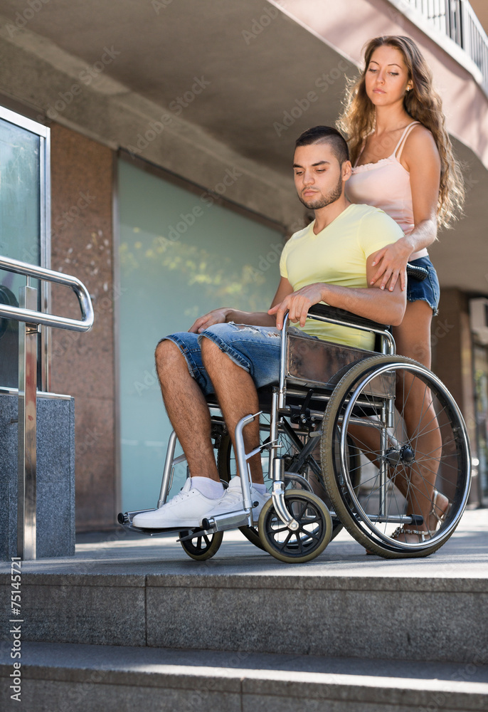 Obraz premium Young man on invalid chair
