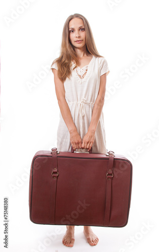 Girl standing with suitcase. Isolated on white