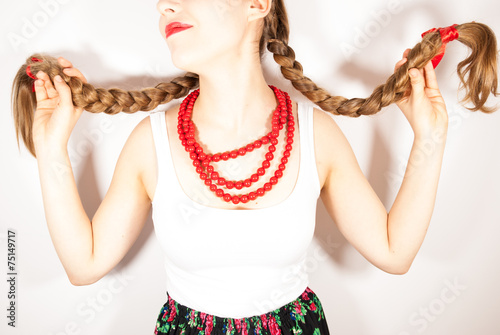 A young beautiful girl wearing folk costume with long tresses
