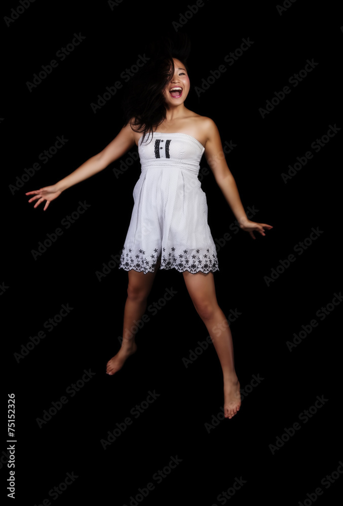 Fototapeta premium Young Attractive Japanese Woman Jumping In Dress