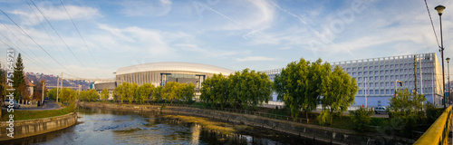 CLUJ-NAPOCA, ROMANIA - 6 NOVEMBER 2014: Cluj Arena stadium and Cluj Sports Holl in Cluj-Napoca, Romania on a sunny autumn day over the Somes river in the European Youth Capital 2015