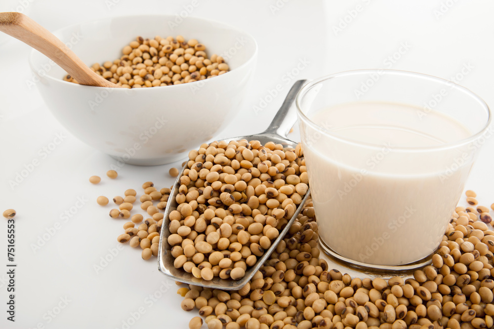 Soy milk in glass with soybeans and  transfer scoop