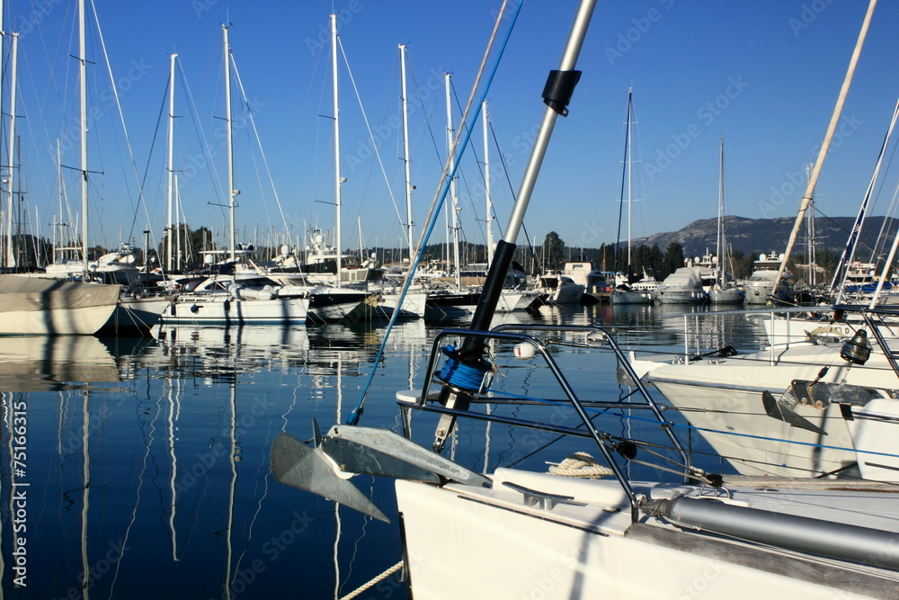 sail Boats and yachts reflected in calm marina