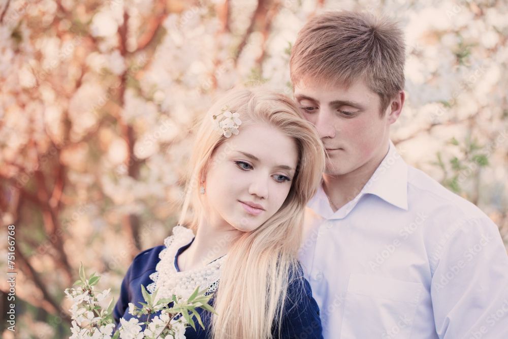 Fototapeta premium young beautiful couple in spring garden